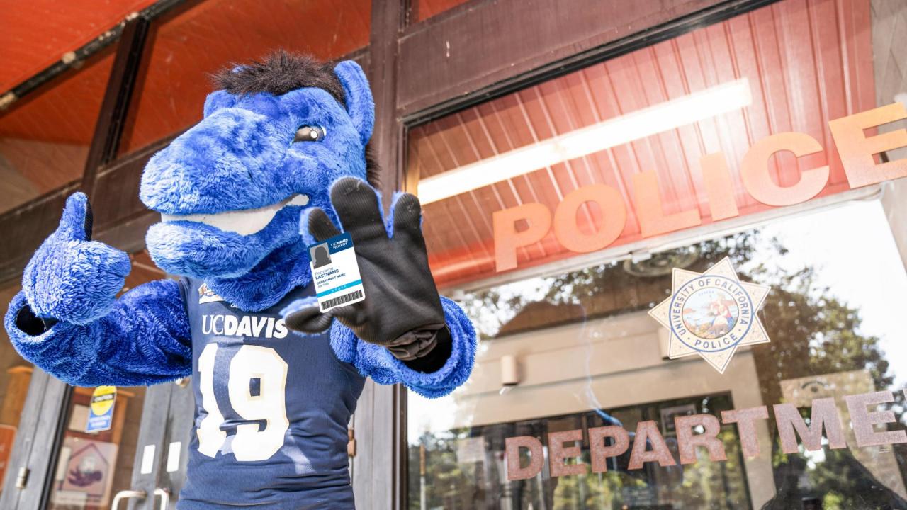 Gunrock mascot holding an AggieAccess card