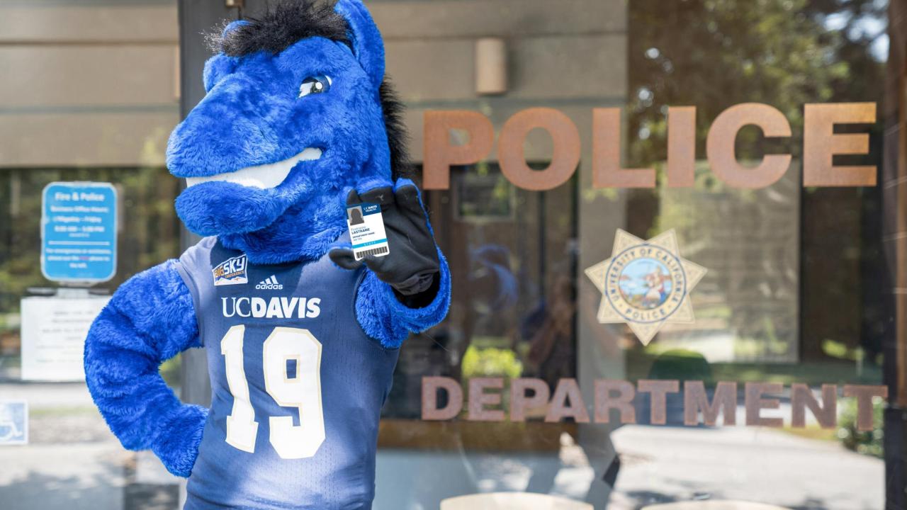 Gunrock mascot holding an AggieAccess card